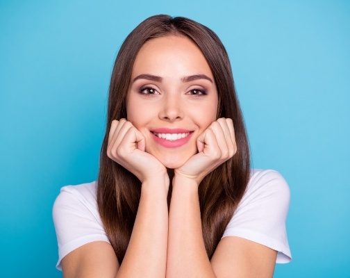 Smiling woman with pale blue background