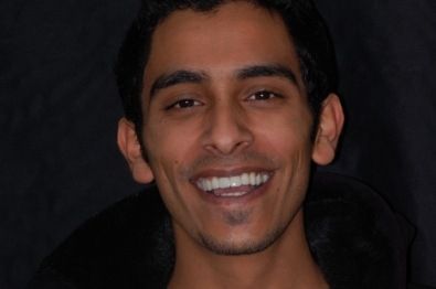 Young man in black jacket smiling with straightened teeth