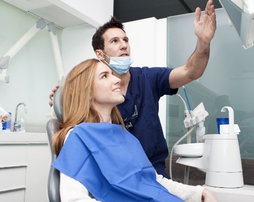 Dentist showing a dental patient something on computer monitor