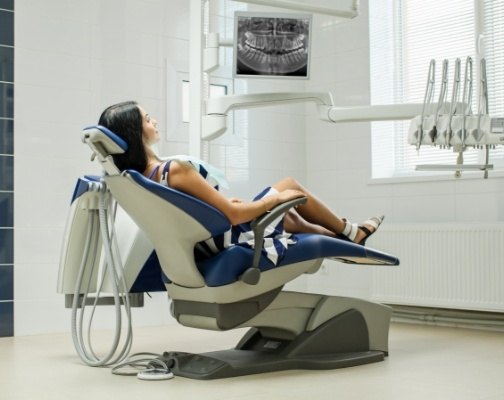 Young woman leaning back in dental treatment chair