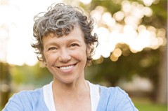 woman smiling while outside 