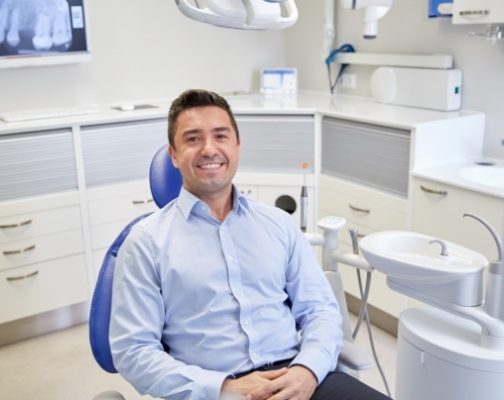 Smiling man sitting in dental chair