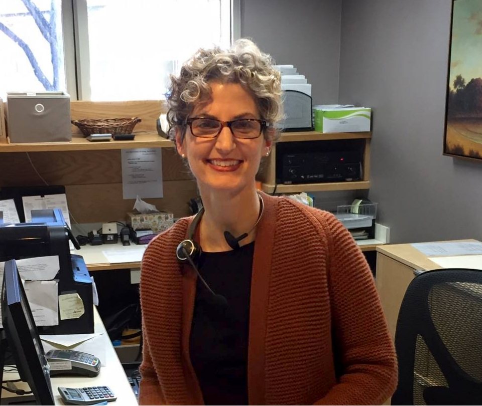 Brookline dental team member Nancy sitting at desk