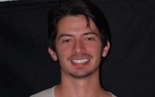 Young man in white shirt grinning