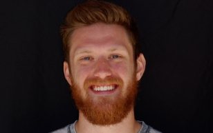 Smiling man with red hair and beard