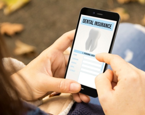 Person looking at dental insurance forms on their phone