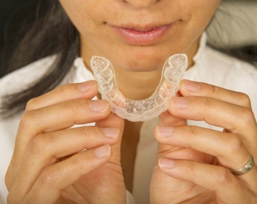 Close up of person holding tray for Invisalign in Brookline