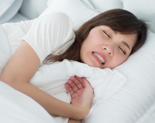 Woman grinding her teeth while sleeping