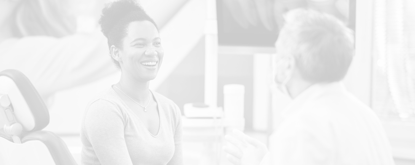 Woman smiling at her dentist during preventive dentistry checkup