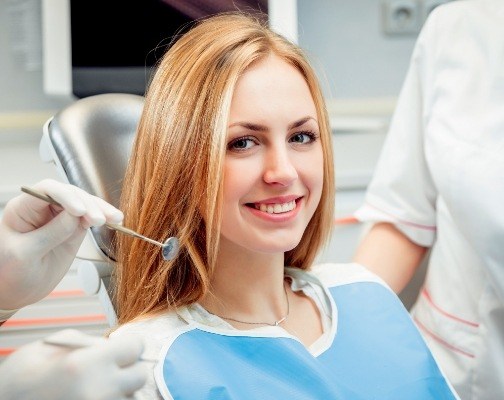 Young blonde woman smiling in dental chair