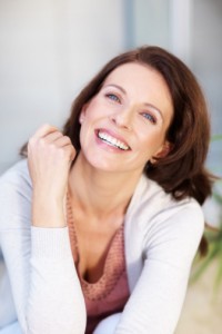 Woman with a beautiful smile thanks to dental implants in brookline 