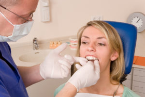 dentist placing invisalign tray