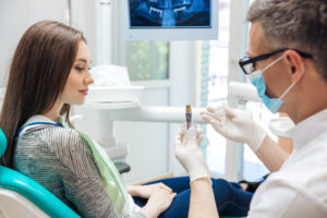 Dentist talkihng to patient about dental implants