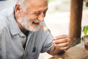 Senior man enjoying a meal with a fork