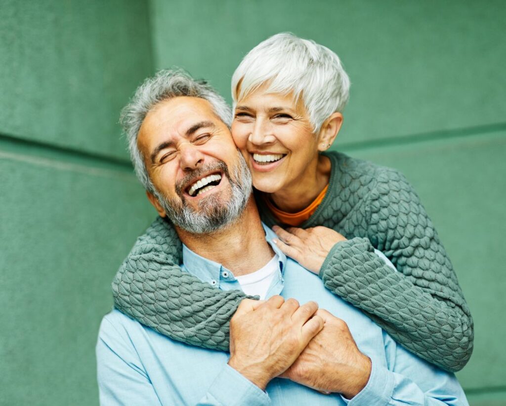 An older man and woman with beautiful teeth