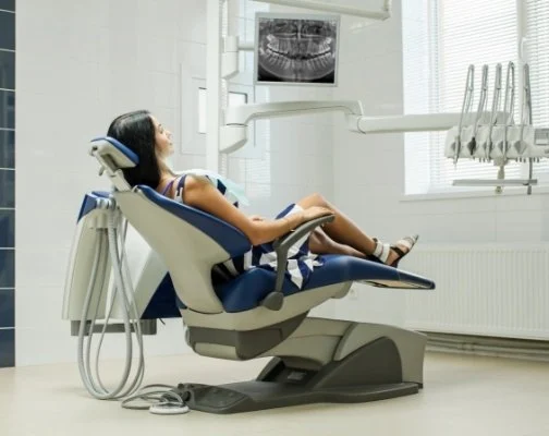 Young woman leaning back in dental treatment chair