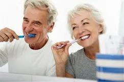 older couple brushing teeth together