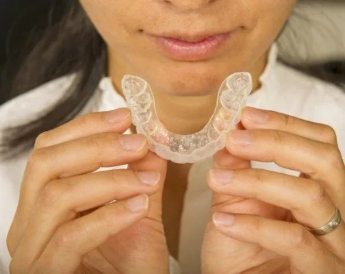 Close up of person holding tray for Invisalign in Brookline