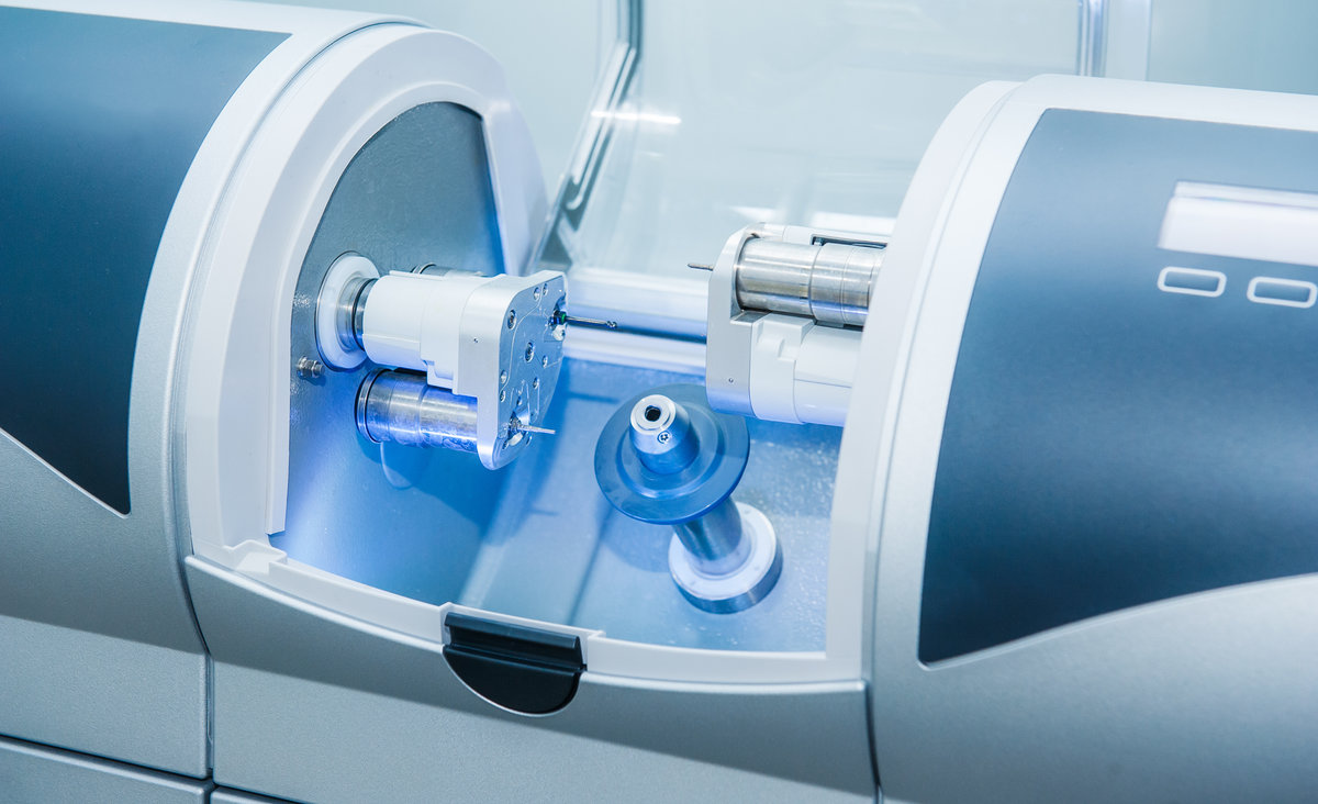 CAD CAM dental computer-aided machine in a highly modern dental laboratory for prosthesis and crowns milling. Dentistry, prostodontics, prosthetics and medical computer technology concept.
